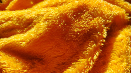 Luxurious orange velvet, soft and cozy, ideal for creating high-quality blanketsの写真素材