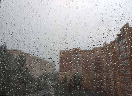 rain in the city. raindrops on the glass. rain drops on window glassの写真素材