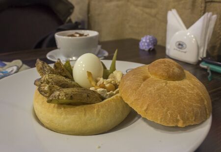 boiled egg with potatoes and hummus in a bunの写真素材