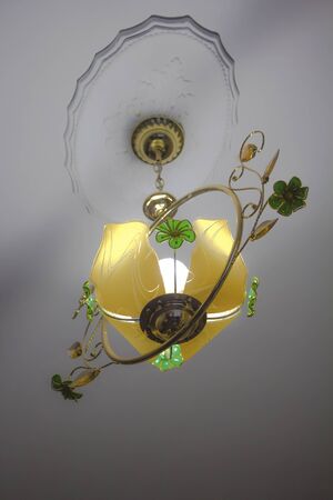 bright yellow on a white ceiling chandelierの写真素材