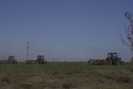 tractor plowed land in a field in springの写真素材