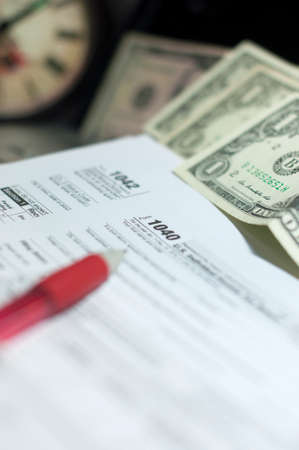 Stock Photo - tax time note pad on yellow paper under silver pen, vintage calculatorの写真素材