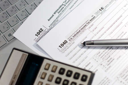 Stock Photo - US individual income tax return form with pen and calculator