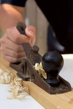 Hands of a carpenter with a planer, workplaceの写真素材