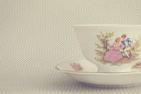 Vintage tea cup over background with zigzags. Antique tea cupの写真素材