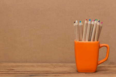Color pencil in the cup on  wooden backgroundの写真素材