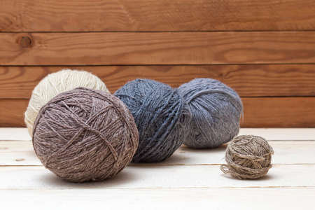 Balls of wool on wooden table. Colorful balls of knitting yarnの写真素材
