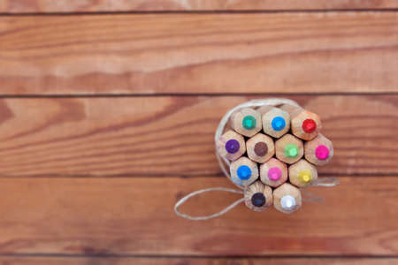Colour pencils. Colored pencils tied in a heap