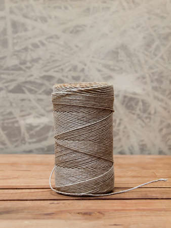 Rope coil on old wooden table. Thread  spoolの写真素材