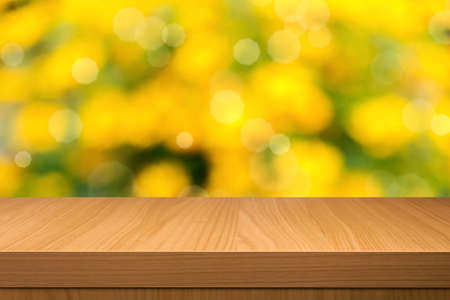 Foliage bokeh background  with empty wooden table. Ready for product montage. Empty wooden table for product display montagesの写真素材