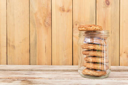 Oatmeal cookies. Oatmeal cookies in glass jar on wooden tableの写真素材