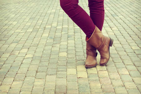 Young girl stands in the shoes crosslegged. Close-up shoesの写真素材