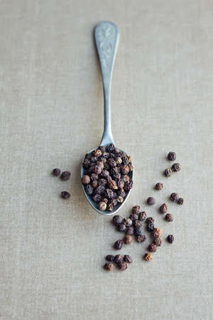 Black Peppercorns on a spoon