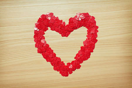 Love heart made with heart-shaped confetti. Valentine's Day card. Space for textの写真素材
