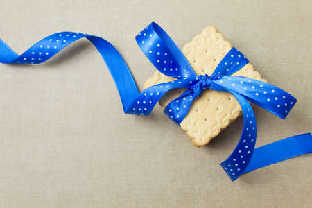 Cookies with blue ribbon. Cookie gift. Top view. Place for your textの写真素材