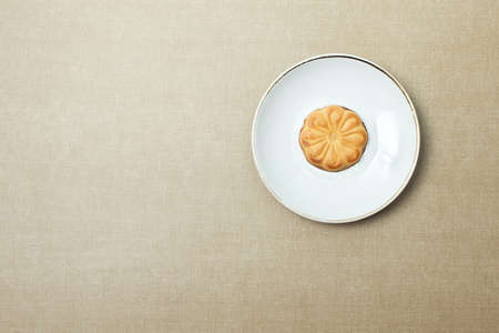 One cookie on a plate on beige backgroundの写真素材
