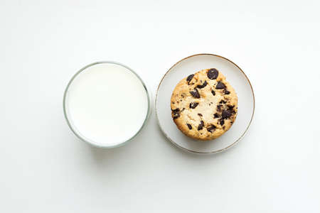 Biscuit cookies with chocolate chips and a glass of milk. Top viewの写真素材