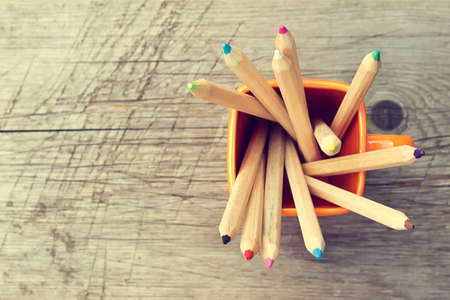 Cup with colorful Pencils on wooden table. Top viewの写真素材