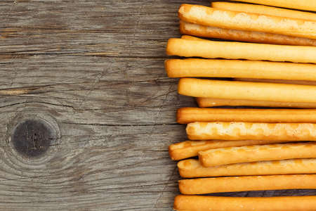 Top view of breadsticks grissini torinesi on wooden background