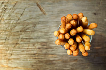 Breadsticks grissini on wooden background. Top view.の写真素材