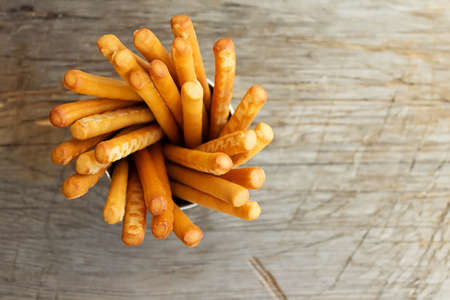 Breadsticks grissini on wooden background. Top view.の写真素材