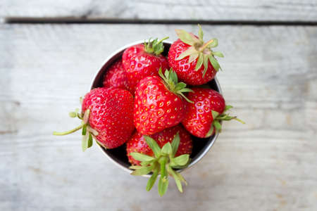 Top view ripe strawberries in an iron bowl. Fresh juicy strawberriesの写真素材