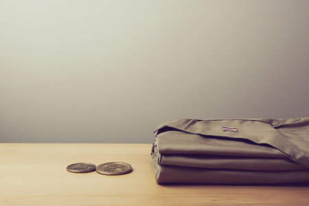 Folded Military Uniform with Medals on Wooden Table - Honoring Soldiers, Veterans, Memorialsの素材