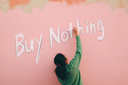 Conceptual Shot of Woman Painting Buy Nothing on Pink Wall - Social Commentary, Minimalist Artの素材