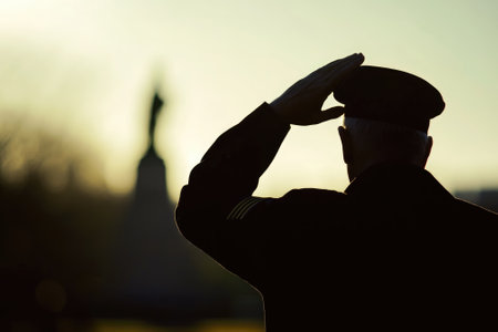 Veteran Saluting Lone Silhouette at Sunset - Memorial Tribute Stock Photo for Patriotic Celebrations and Eventsの素材