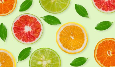 Variety of whole and sliced citrus fruits , lemon, lime,grapefruit and orangeの写真素材