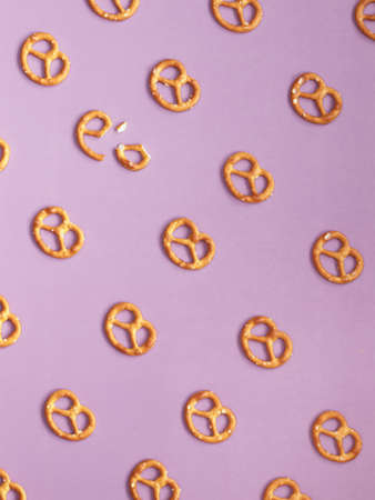 Yellow pretzel pattern on the violet backgroundの写真素材