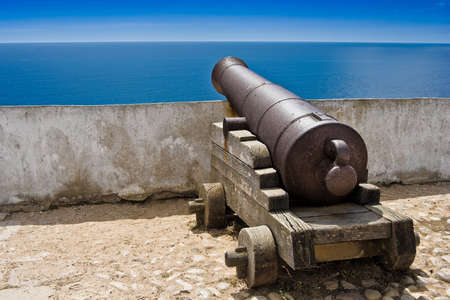 Old fashioned sea cannon aimed at sea in Portugal