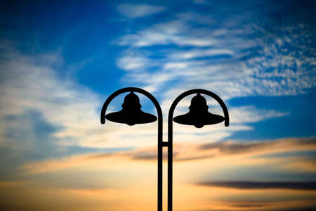 old lantern at sunset time with nice colored sky at backgroundの写真素材