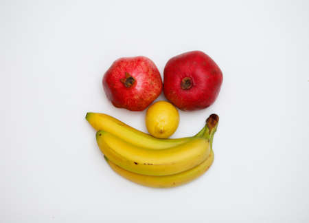 face made of fruits on wooden backgroundの写真素材