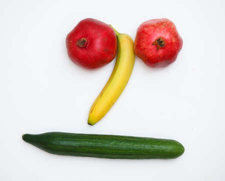 face made of fruits on wooden backgroundの写真素材