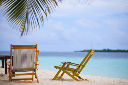 Relaxing on tropical paradise with white sand at Maldives and green palms with blue skyの写真素材