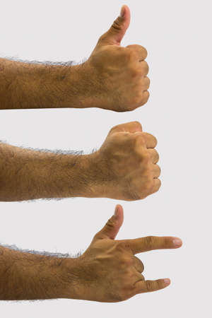 Fist hand thumb index finger little finger on a gray background の写真素材