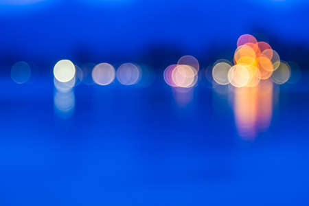Blurred lights reflecting water  の写真素材