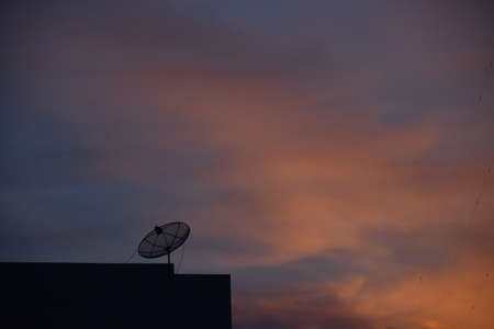 Satellite dish with evening sky.の写真素材
