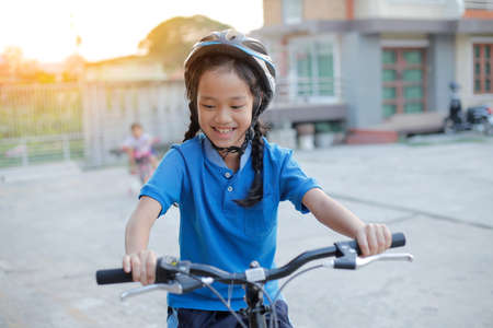child girl with folding bike.の写真素材