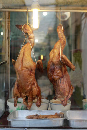 Roasted ducks hang outside of a Chinese restaurant, Bangkok, Thailand.の写真素材