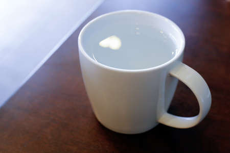 White cup on wood table.の写真素材
