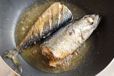 Frying fishes in frying pan.の写真素材