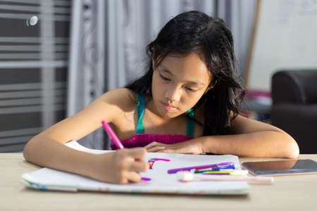 Asian lovely Child girl with art at home.の写真素材