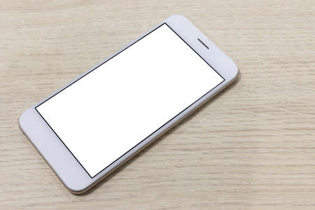 smartphone at wooden desk background. template for design. empty and minimalistic.