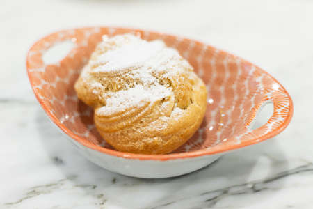 Homemade Choux pastry with cream on cup.の写真素材