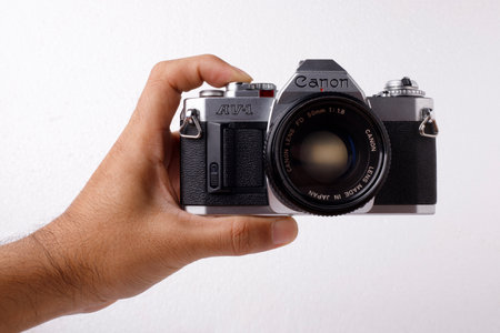 BANGKOK, THAILAND - February 12, 2020 :  Canon AV-1, interchangeable lens camera, with 50 mm lens on white background, Illustrative Editorial.のeditorial素材