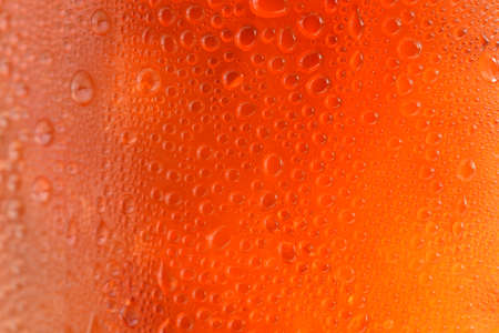 Black drop of orange-yellow water dropletsの写真素材