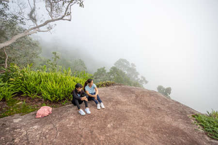 Mother daughter nature travel in misty tropical forest.の写真素材