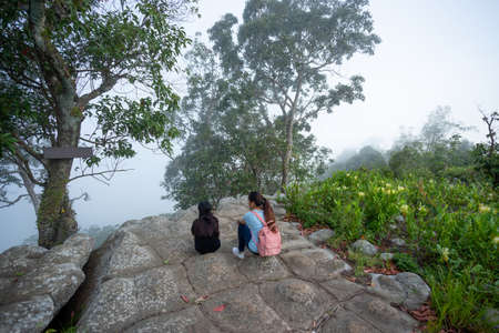 Mother daughter nature travel in misty tropical forest.の写真素材